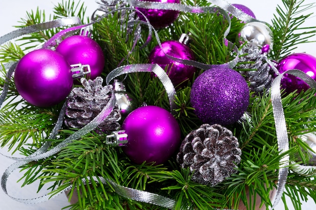 Christmas greenery with silver glitter cones and purple ornaments