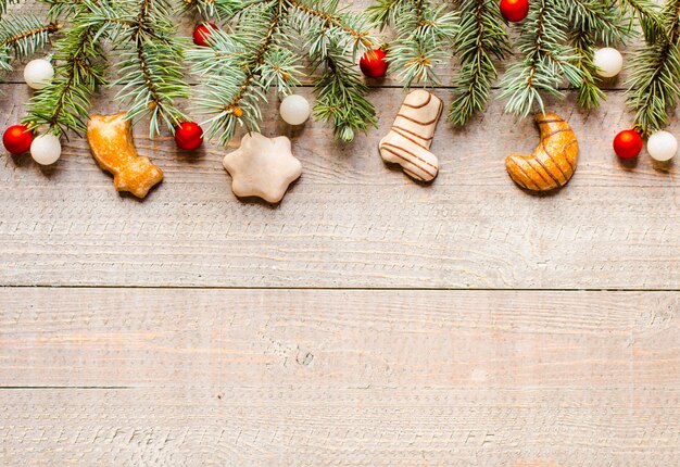 Christmas holiday background with ornaments on rustic wooden background.