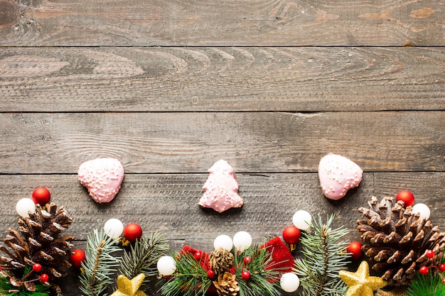 Christmas holiday background with ornaments on rustic wooden background.