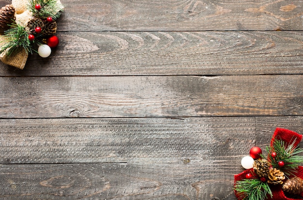 Christmas holiday background with ornaments on rustic wooden background.