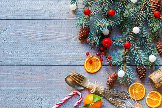 Christmas holiday background with ornaments on rustic wooden background.