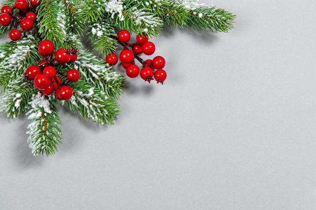 Christmas Holidays decoration with red berries on grey background