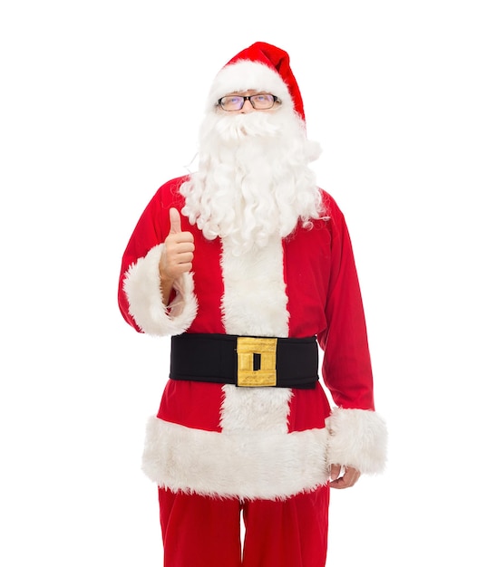 christmas, holidays, gesture and people concept- man in costume of santa claus showing thumbs up