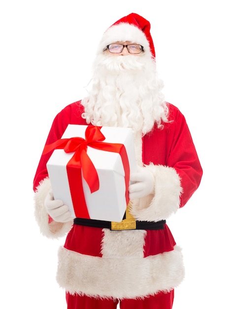 christmas, holidays and people concept - man in costume of santa claus with gift box