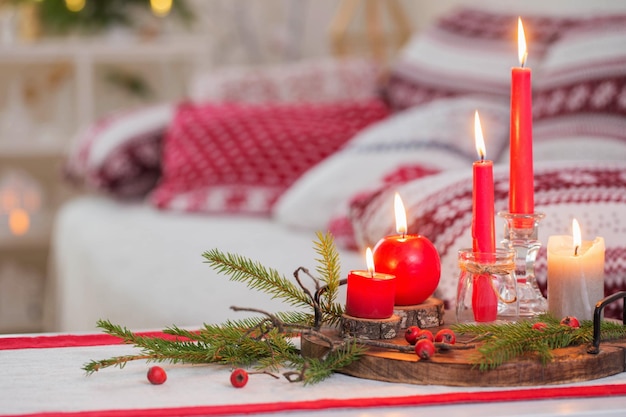 Christmas home decorations with candles in red and white colors