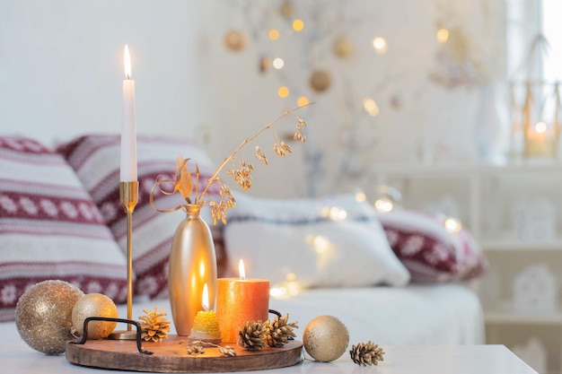 christmas home decorations with candles in white interior