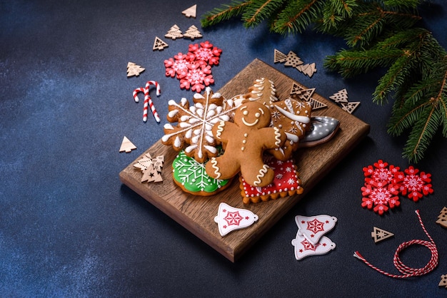 Christmas homemade gingerbread cookies on a dark concrete table table