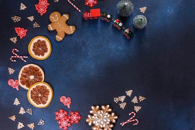 Christmas homemade gingerbread cookies on a dark concrete table