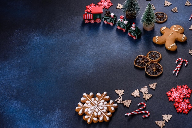 Christmas homemade gingerbread cookies on a dark concrete table