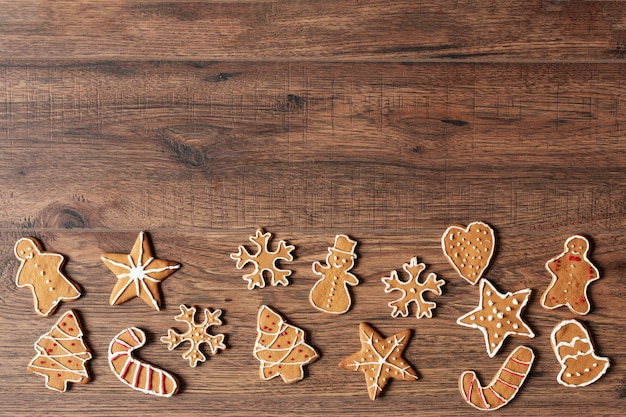 Christmas homemade gingerbread cookies on wooden background top view with copy space