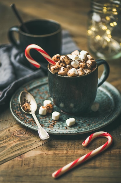 Christmas hot chocolate with marshmallows and cocoa on wooden background