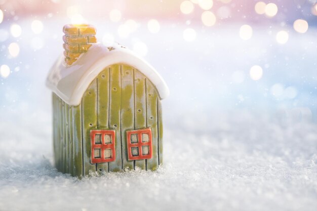 Christmas house on snow and golden lights