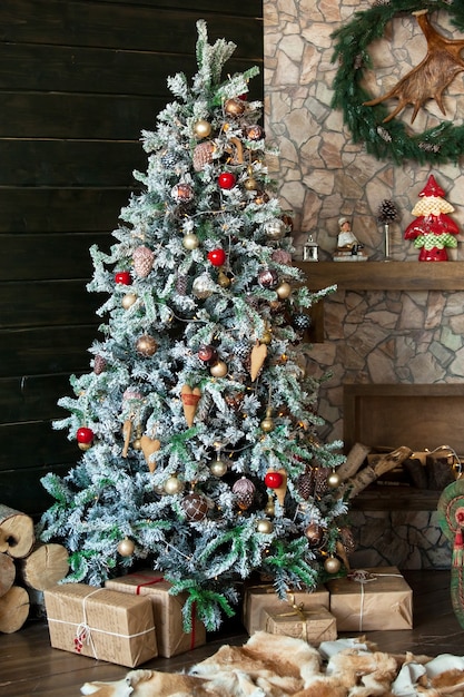 christmas indoor decoration with fir tree and gifts