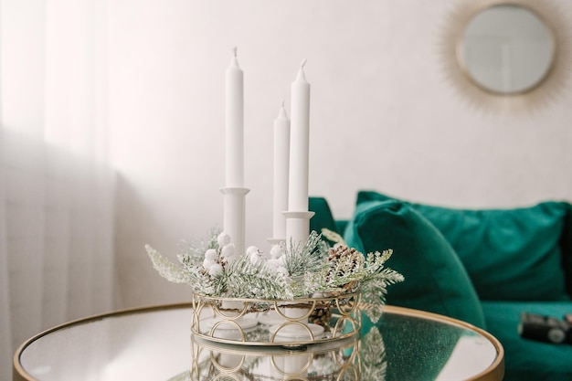 Christmas interior decor with candles and spruce