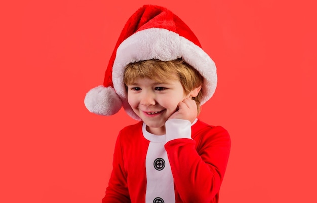 Christmas kid cute child in santa claus hat new year celebration winter holiday closeup portrait