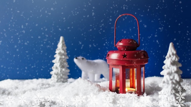 Christmas lantern on snow with snowy fir trees and white bear