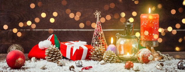 Christmas Lantern on snowy table with festive decoration.