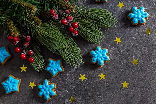 Christmas layout spruce branches red winter berries blue gingerbread copy space