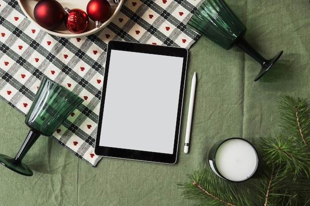 Christmas Layout on the Table with Decorations Tablet with Blank Screen for your Advertising Mockup