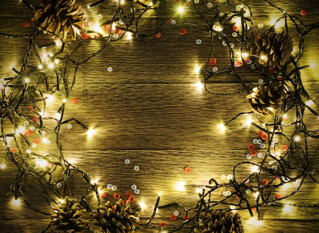 Christmas Light on Wooden Background Top View with Copyspace