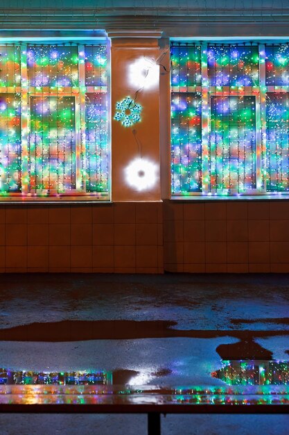 Christmas lights wet bench and rain puddle