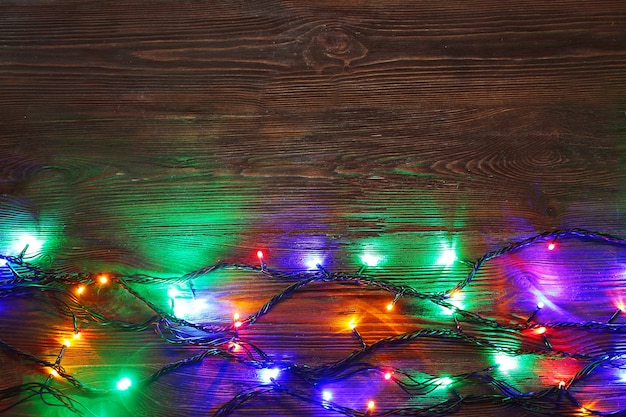 Christmas lights on a wooden background