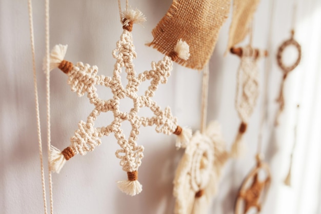 Christmas macrame decor Christmas toy from natural materials cotton thread wood beads and stick Eco decorations ornaments hand made decor Winter and New Year holidays Closeup