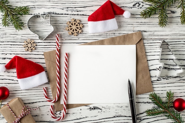 Christmas mail, envelopes with letters on a light wooden table.