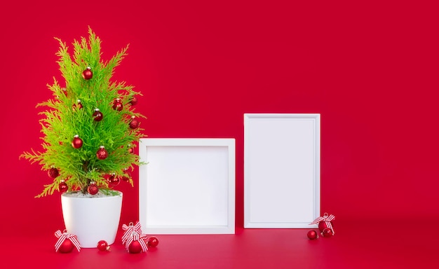 Christmas mockup on a red background a small Christmas tree and two white frames for te xt