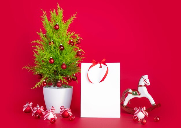 Christmas mockup on red background with New Year's gift and decorative elements