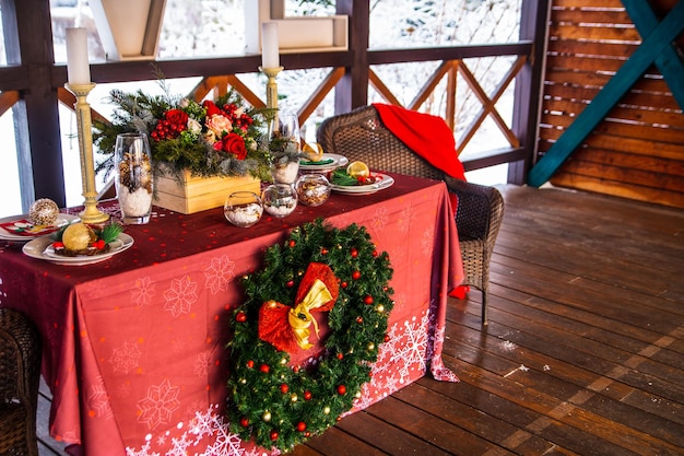 Christmas mood holiday atmosphere Festive table decor on a wooden veranda