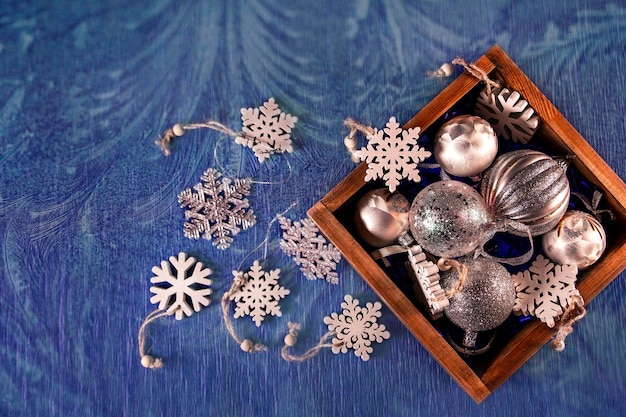 Christmas mood holiday atmosphere Silvery Christmas balls on a blue background with copy space