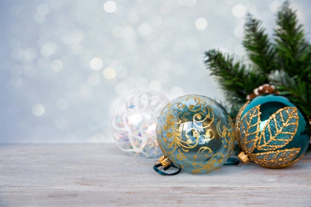 Christmas mood New Year background Christmas tree branches and Christmas balls on a wooden table