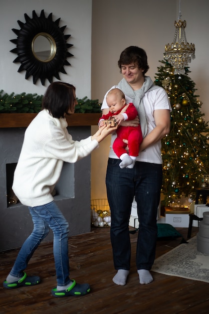 Christmas morning with mother, father and little boy at home