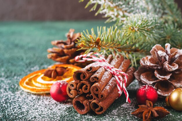 Christmas natural composition with cinnamon, pine cones and dry oranges