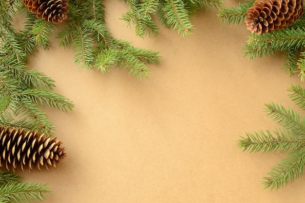 Christmas or New Year background. christmas tree, green fir branches cones on kraft paper background