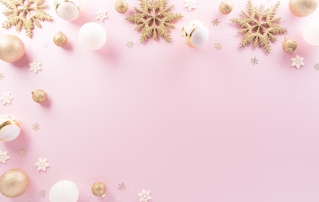 Christmas and new year background concept Top view of Christmas ball star and snowflake on pastel pink background