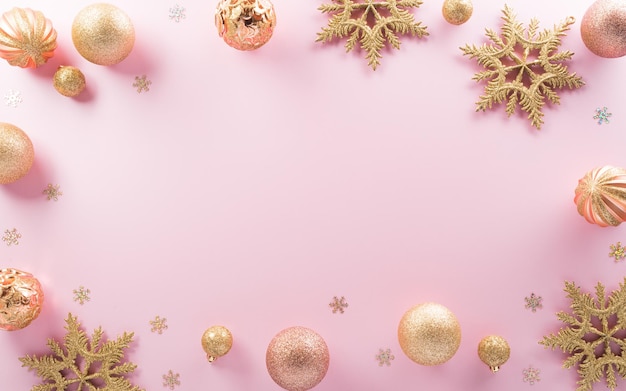 Christmas and new year background concept Top view of Christmas ball star and snowflake on pastel pink background