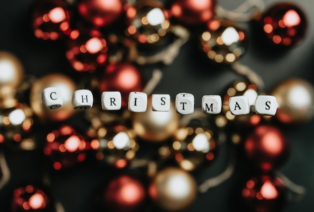 Photo christmas new year background mock up flat design, lettering merry christmas, floating word colorful brilliant background, copy space, happy day ,banner, gold red and black out of focus background