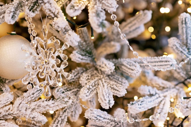 Christmas and New Year background, tree decorated with lights and crystal New Year decoration. Soft selective focus.