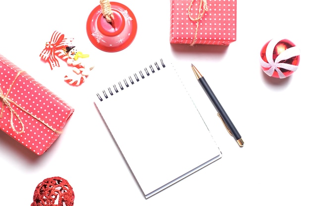 Christmas and New Year background with notepad pen and red decorations To make a list or list of promises space for your text Mockup