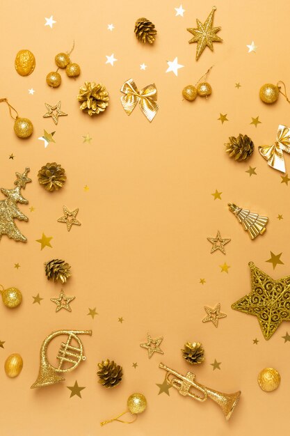 Christmas and new year composition flat lay with golden decorations on beige