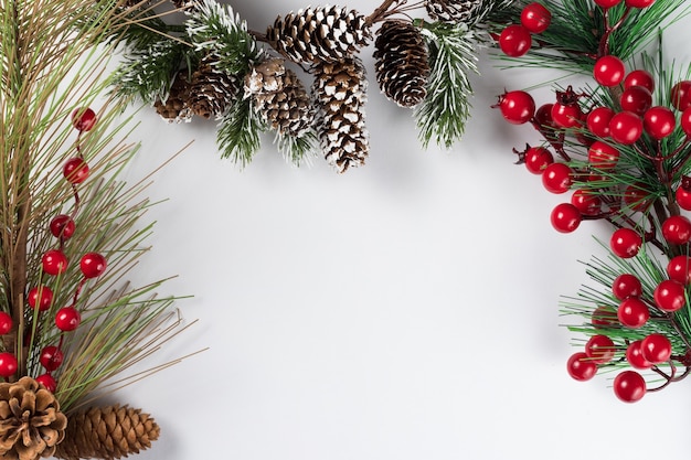 Christmas new year composition on white background. Fir branches, christmas decoration. Flat lay, top view, copy space.