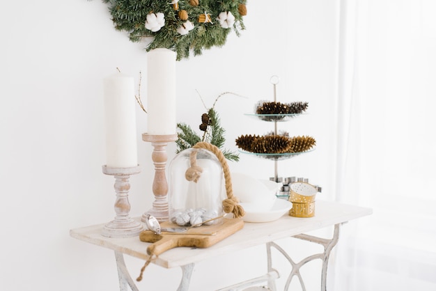 Christmas and new year decor on the coffee table in the living room in the house. Candles and cones