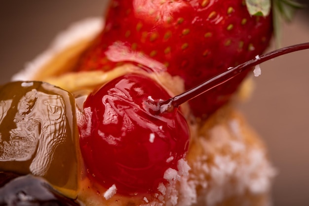 Christmas and New Year decoration, with sweets covered with strawberry and cherry. Ideal for background with copy space. Selective focus.