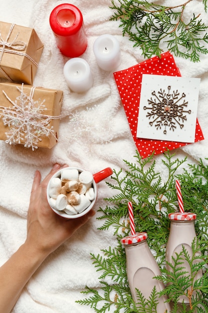 Christmas and New Year festive cozy arrangement, woman's hands hold a mug of cocoa or choc