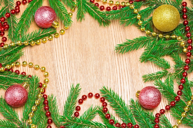 Christmas and New Year frame background Christmas balls and beads with spruce branches Copy space