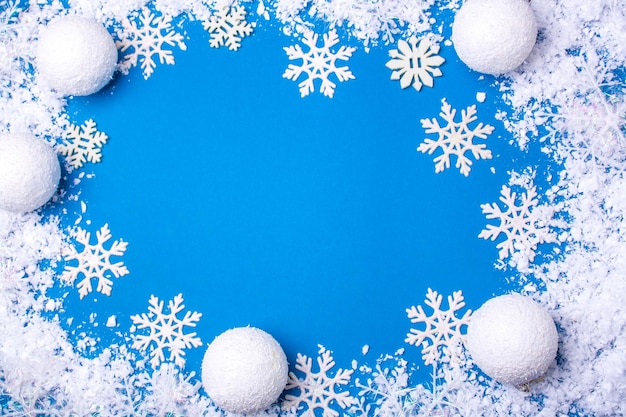 Christmas and New Year frame made of snowflakes snow and white Christmas balls Empty space