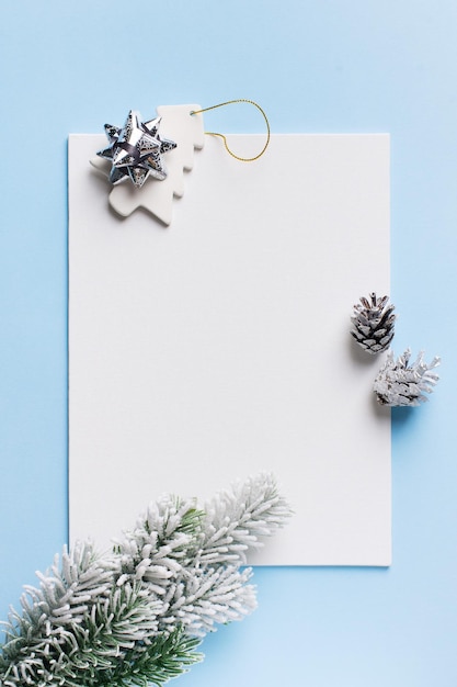 Christmas and new year goal planning mock up with note and decoration on blue background and backdrop flat lay copy space top view vertical