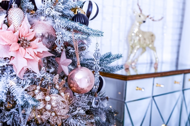 Christmas or New Year red decorative ball on a festively decorated tree Christmas wall Selective soft focus Bokeh